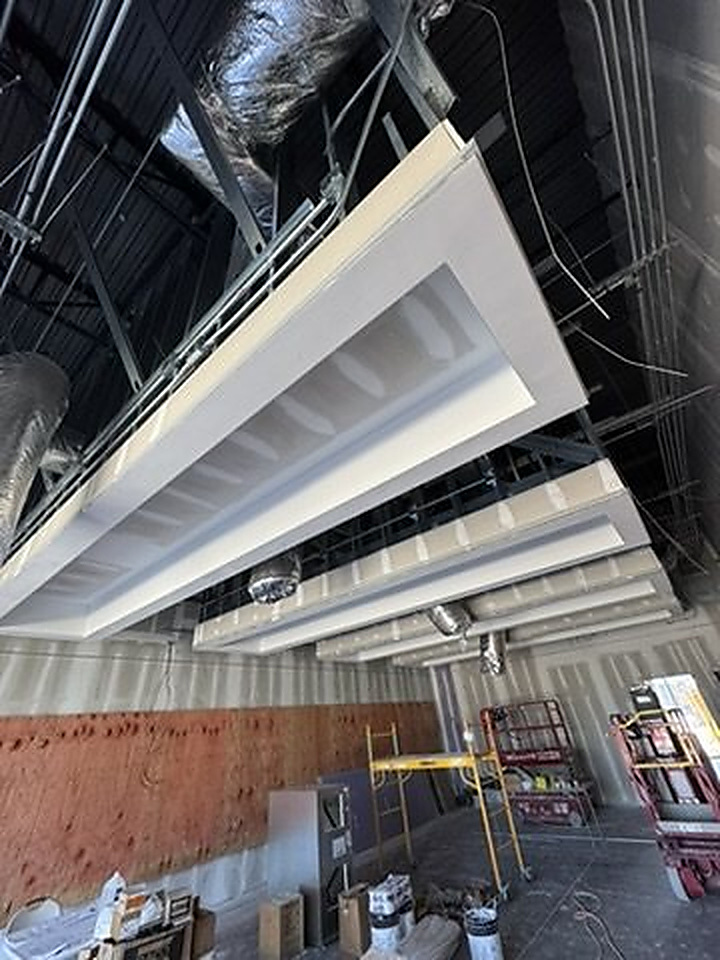 Finished architectural drywall ceiling and soffit assembly in a commercial interior