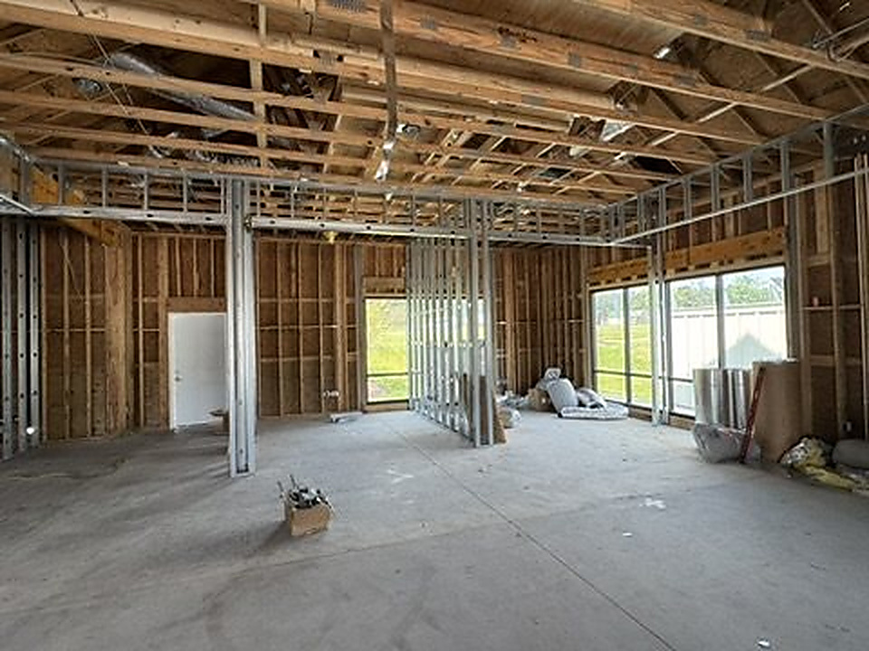 Interior metal stud framing with door and window openings on a commercial build-out